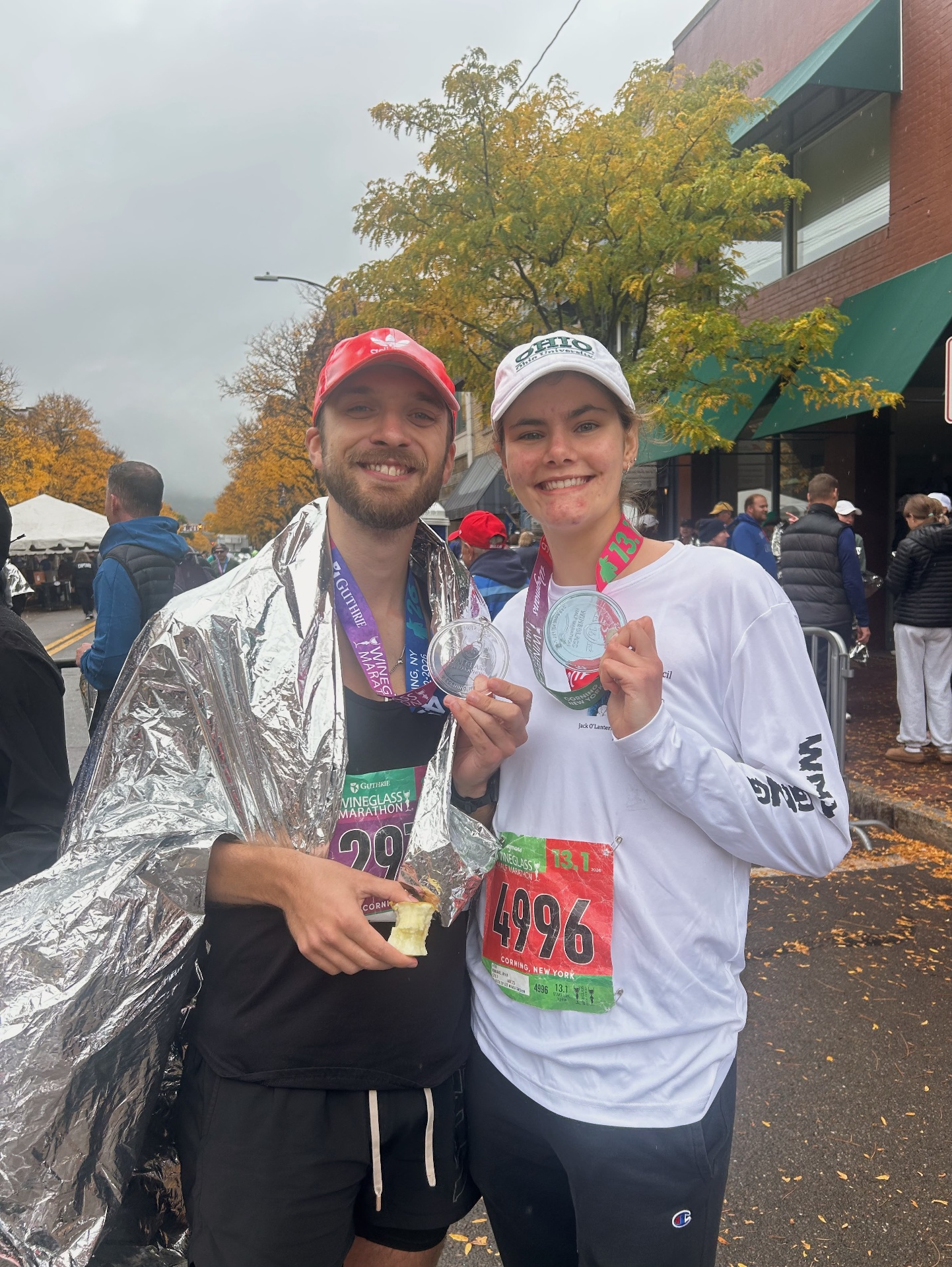 Marathon finishers showing their medals in Corning, New York